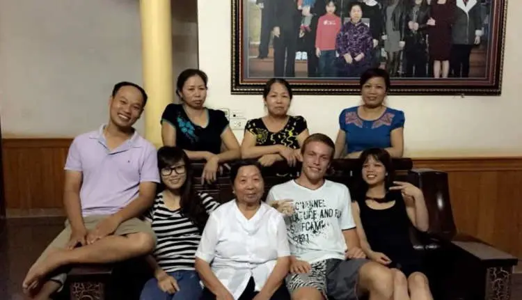 Nam's family and me sitting in a living room.