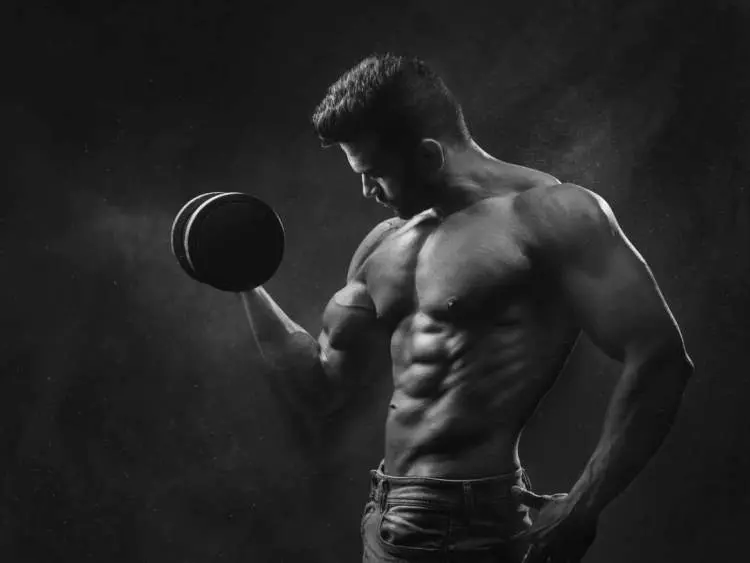 Man holding black dumbbell.