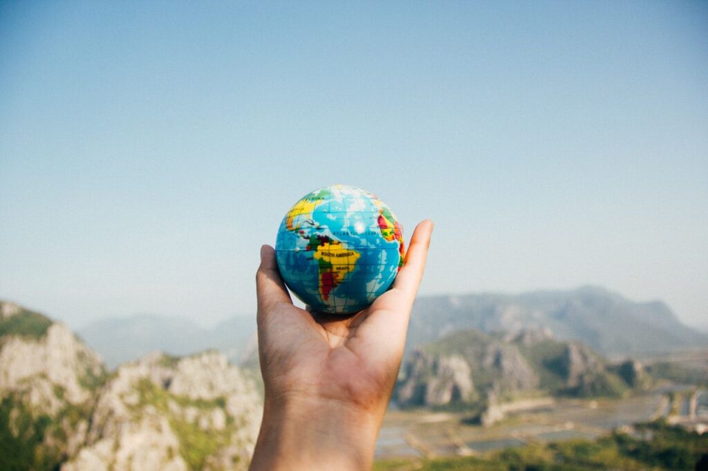 Let's go out of our comfort zone. Man holding in his left hand a globe.